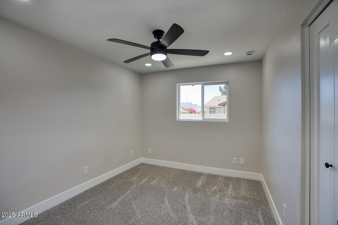 1561 North 26th Street Mesa, AZ 85213 - Photo 26 of 35 an empty room with a window and a fan