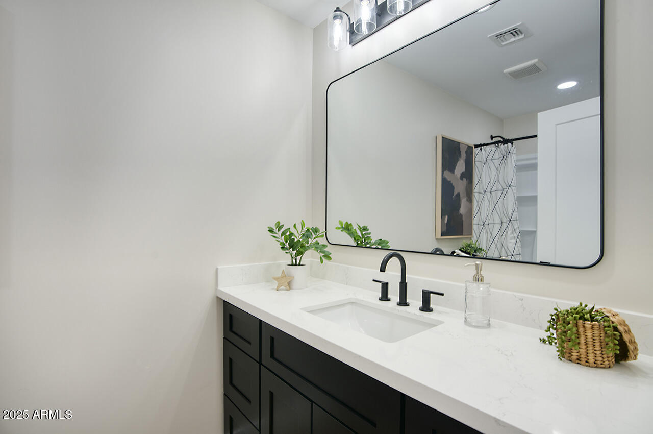 1561 North 26th Street Mesa, AZ 85213 - Photo 28 of 35 a bathroom with a sink and a mirror