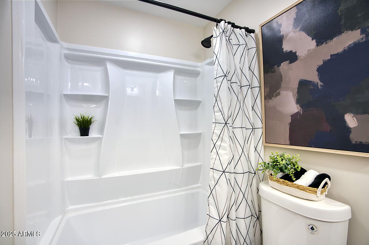 1561 North 26th Street Mesa, AZ 85213 - Photo 29 of 35 a bathroom with a bathtub and shower