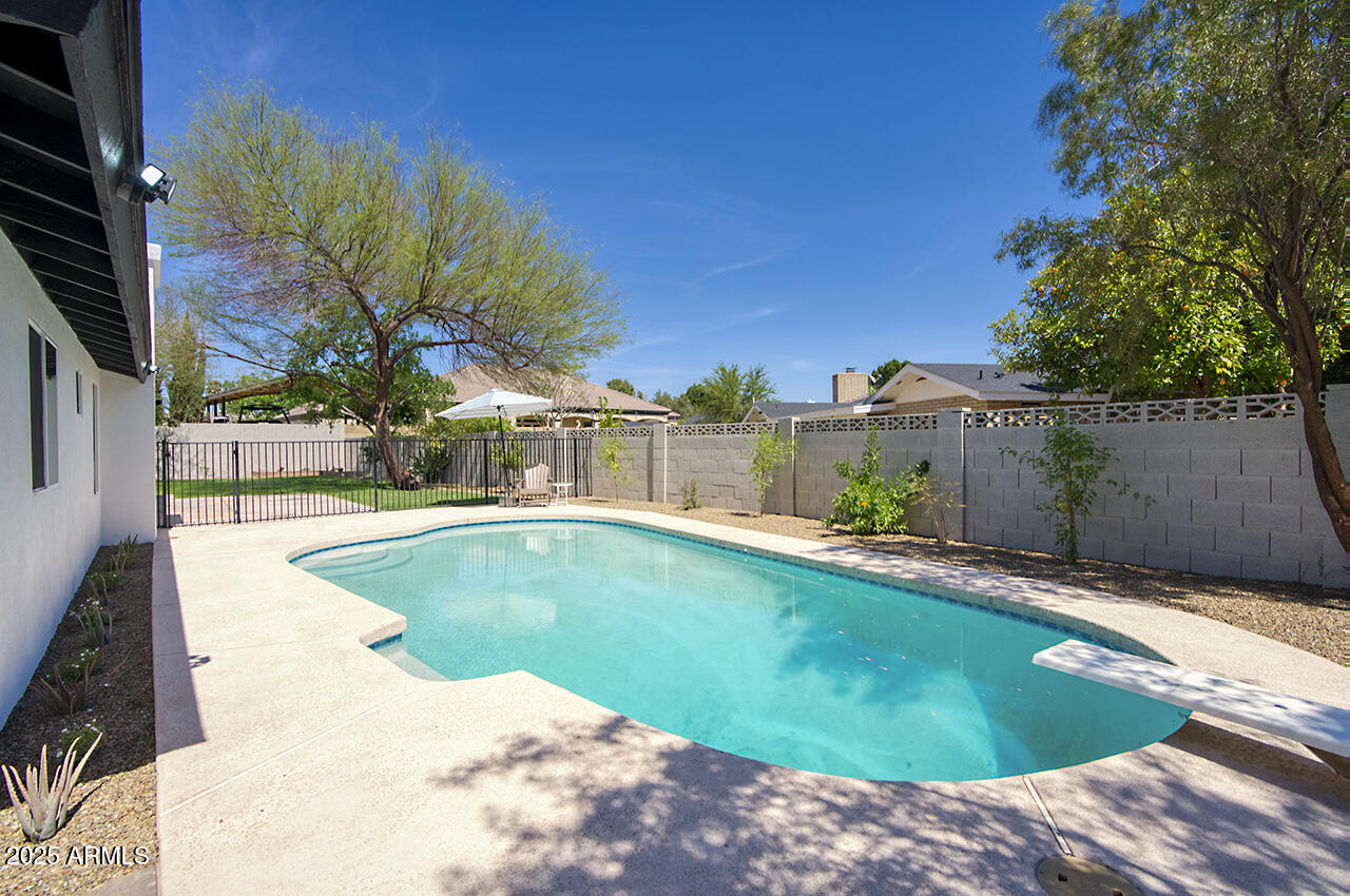 1561 North 26th Street Mesa, AZ 85213 - Photo 34 of 35 a view of a swimming pool with an outdoor seating and a pathway