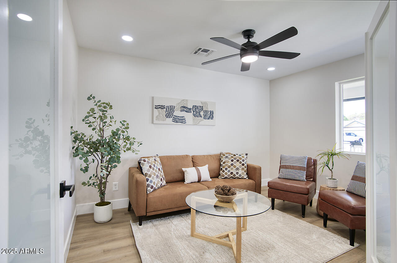1561 North 26th Street Mesa, AZ 85213 - Photo 6 of 35 a living room with furniture and a potted plant