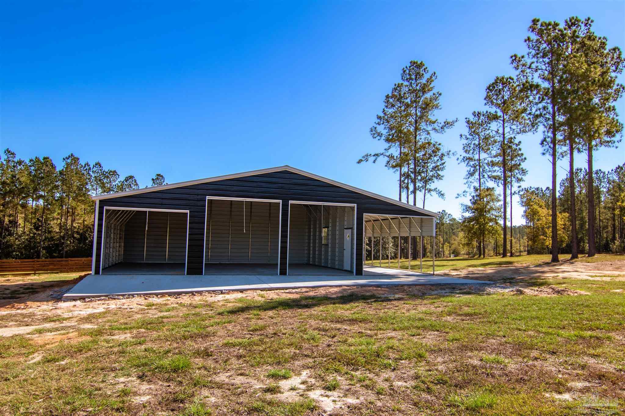 2232 Bison Drive Pace, FL 32571 - Photo 13 of 27 a front view of a house with a yard