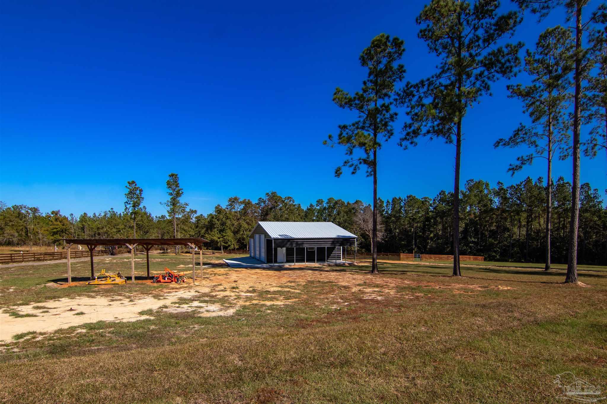 2232 Bison Drive Pace, FL 32571 - Photo 16 of 27 a view of a house with a yard