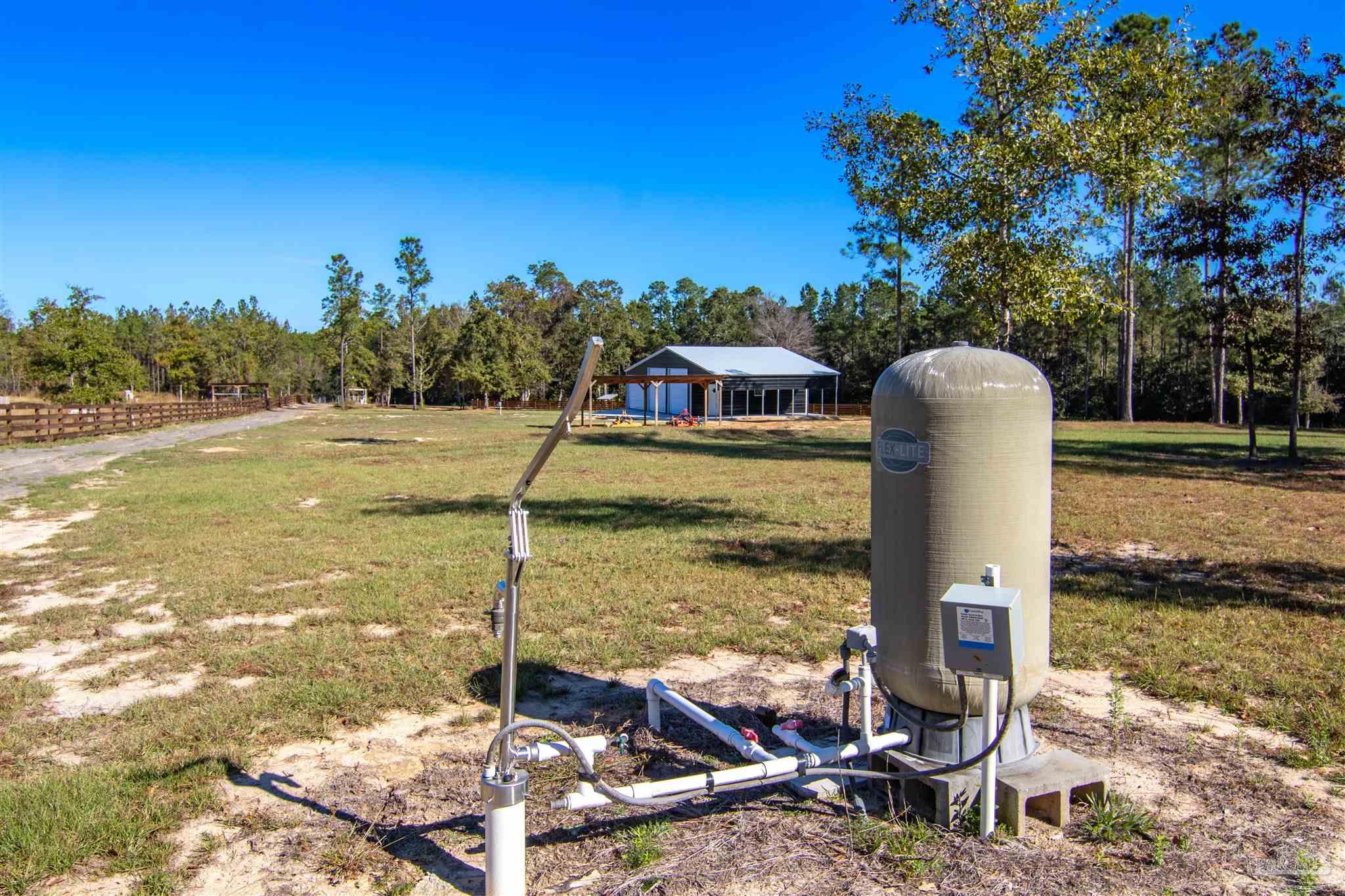 2232 Bison Drive Pace, FL 32571 - Photo 18 of 27 a view of a lake with a house in the background