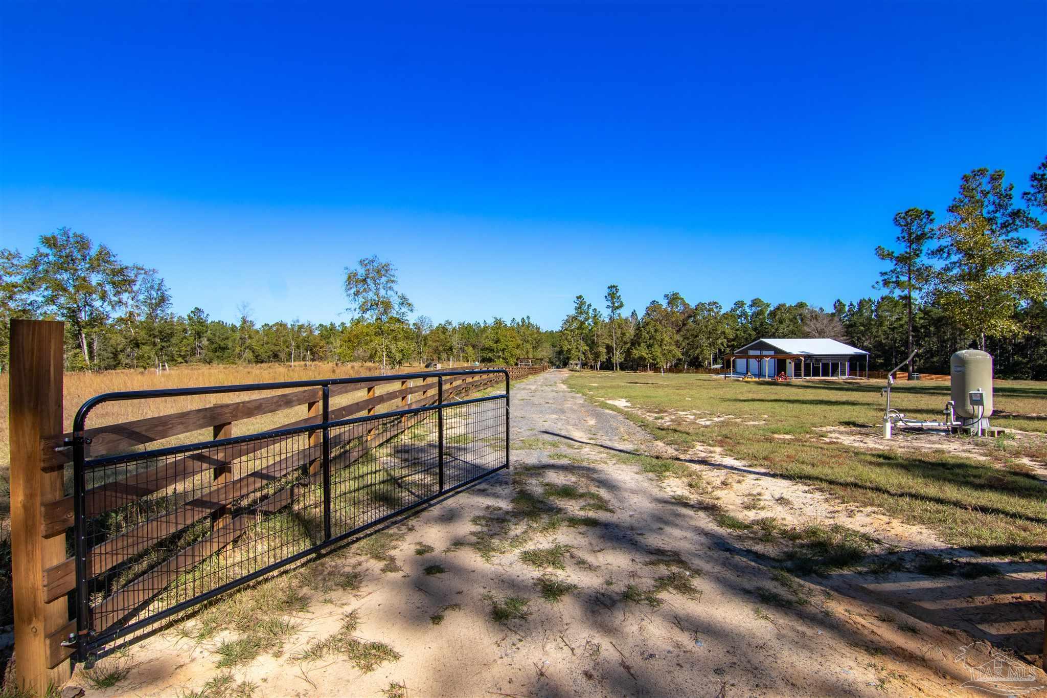 2232 Bison Drive Pace, FL 32571 - Photo 19 of 27 a view of a yard with wooden fence