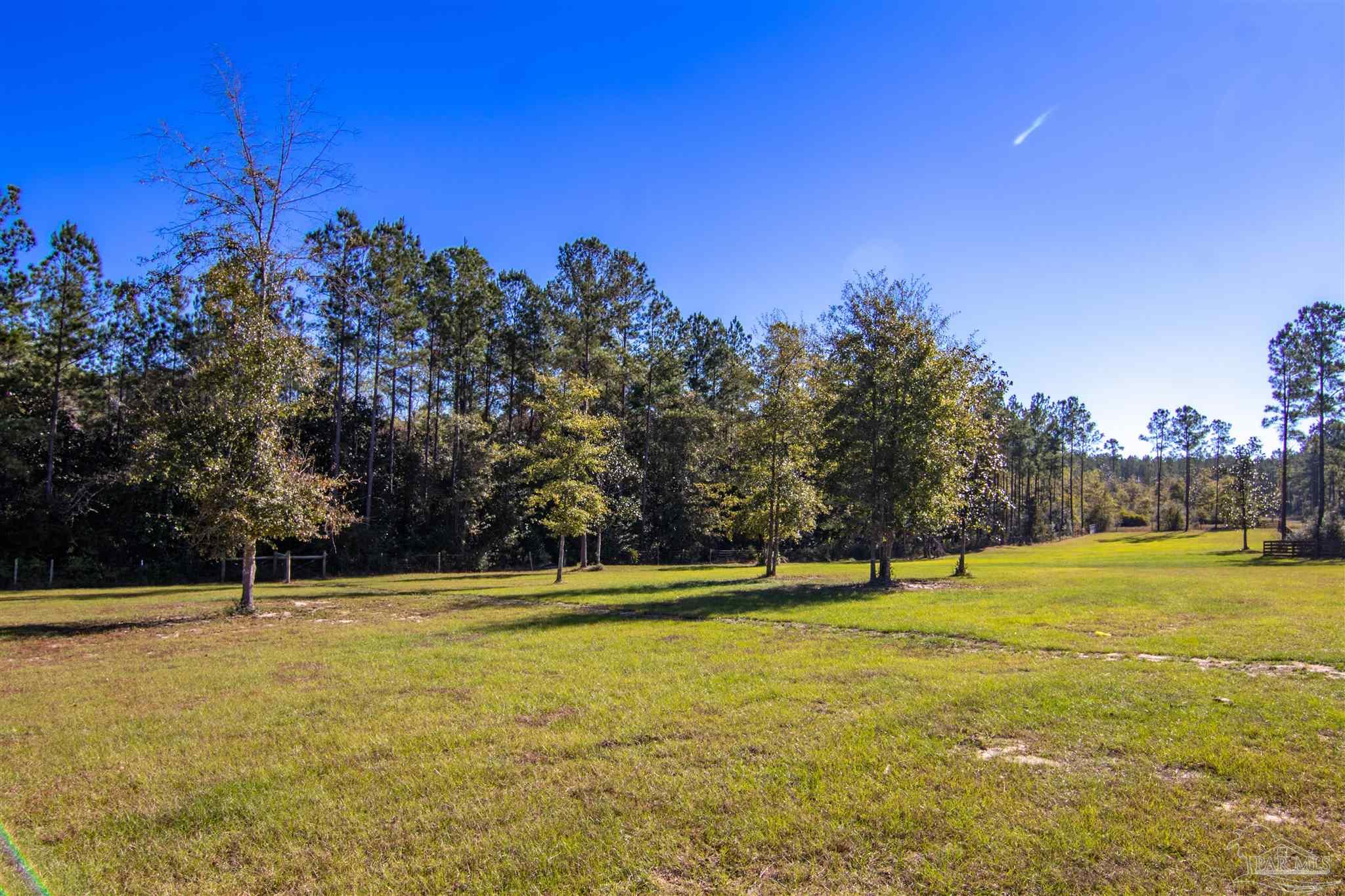 2232 Bison Drive Pace, FL 32571 - Photo 5 of 27 a view of swimming pool with an outdoor space and seating area