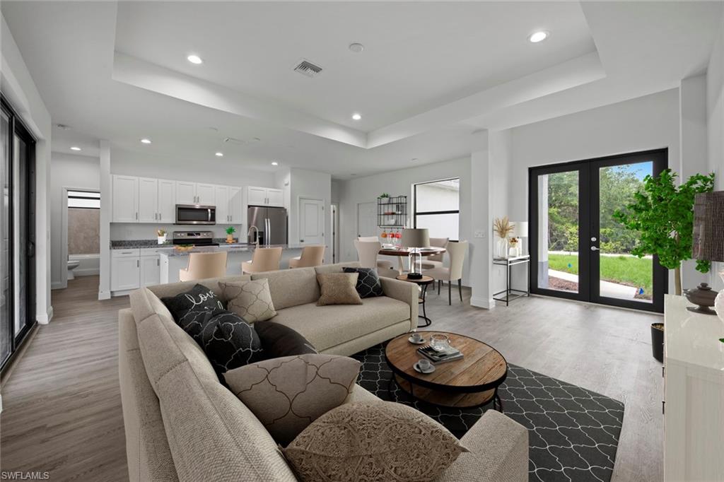 a living room with furniture and a large window with outer view