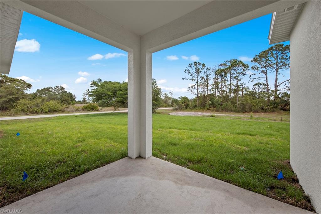 355 Ranier Avenue Lehigh Acres, FL 33974 - Photo 20 of 27 a view of a yard with a tree