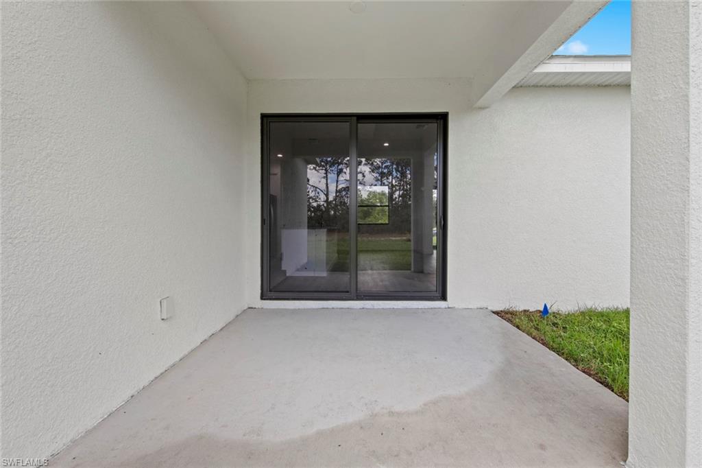 355 Ranier Avenue Lehigh Acres, FL 33974 - Photo 21 of 27 a view of an empty room with a fireplace