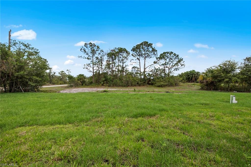 355 Ranier Avenue Lehigh Acres, FL 33974 - Photo 22 of 27 a view of a golf course with a garden