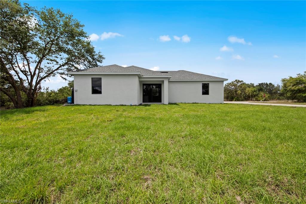 355 Ranier Avenue Lehigh Acres, FL 33974 - Photo 23 of 27 a house with a tree in front of it