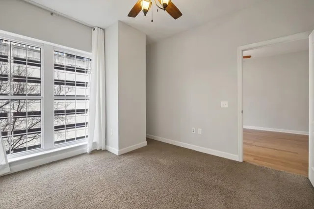 an empty room with fan and entrance