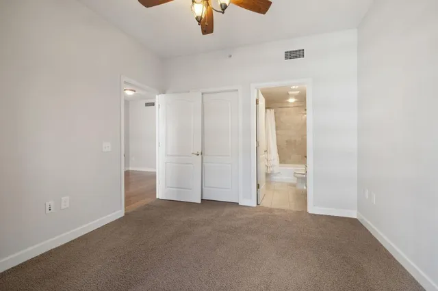 a bathroom with a granite countertop sink toilet a mirror a bathtub and shower