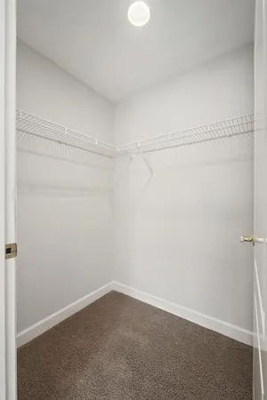 a kitchen with granite countertop white cabinets and stainless steel appliances