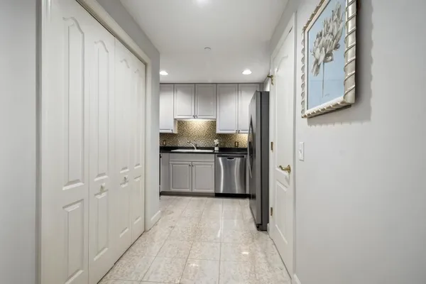 a view of a hallway with wooden floor and entryway