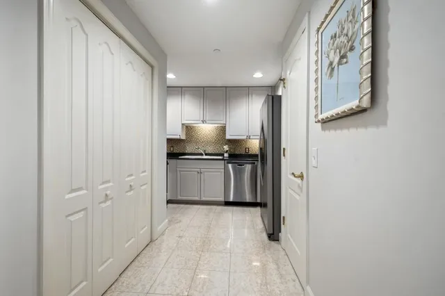 a view of a hallway with wooden floor and entryway