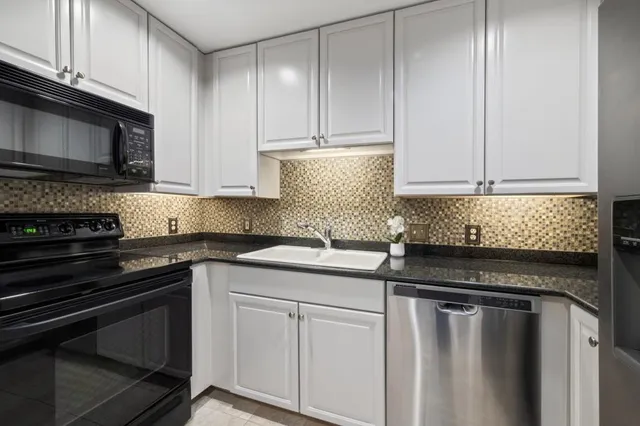 a kitchen with a sink and cabinets