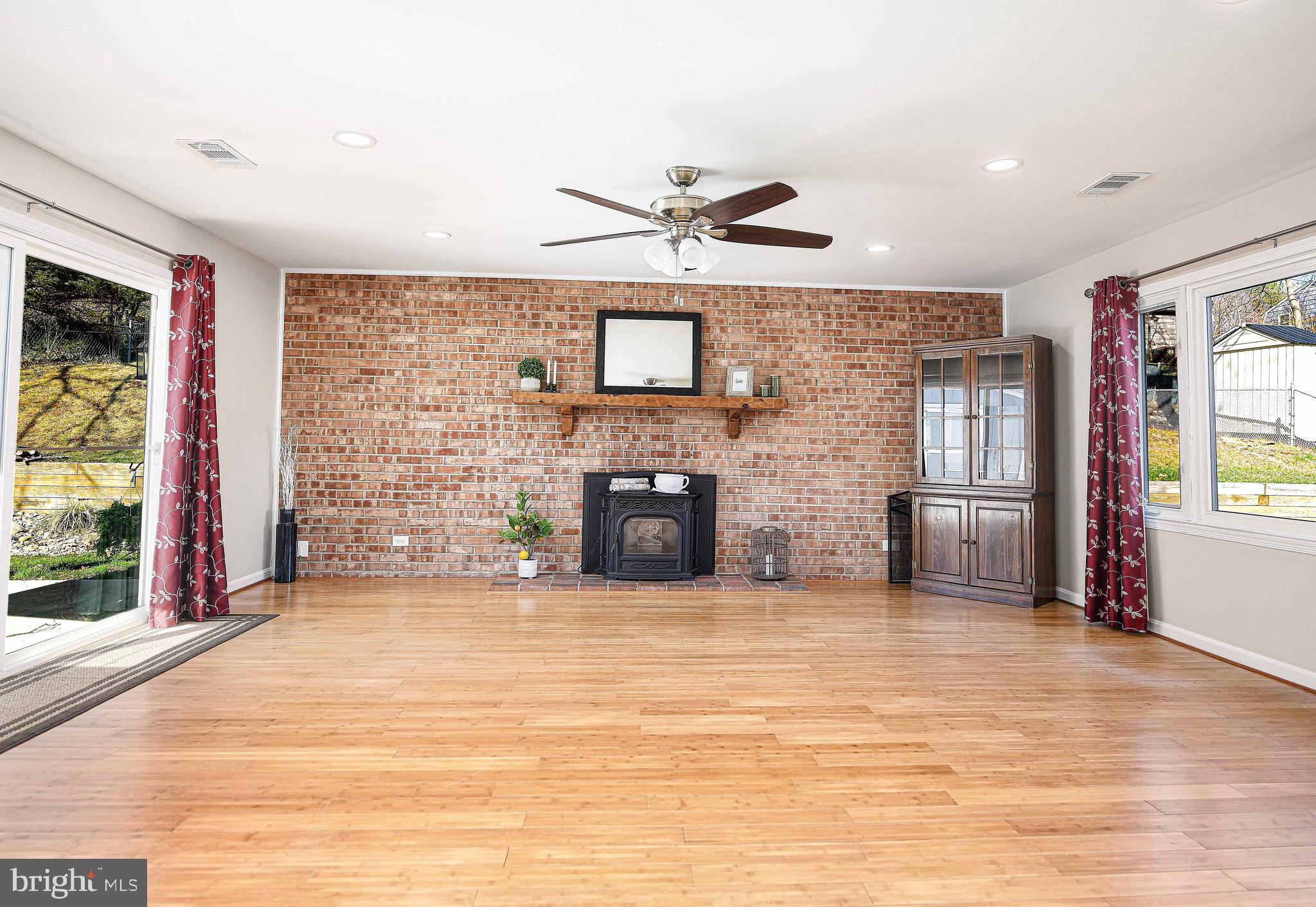807 Ferguson Road Joppa, MD 21085 - Photo 23 of 44 Brick wall accent w/ pellet stove