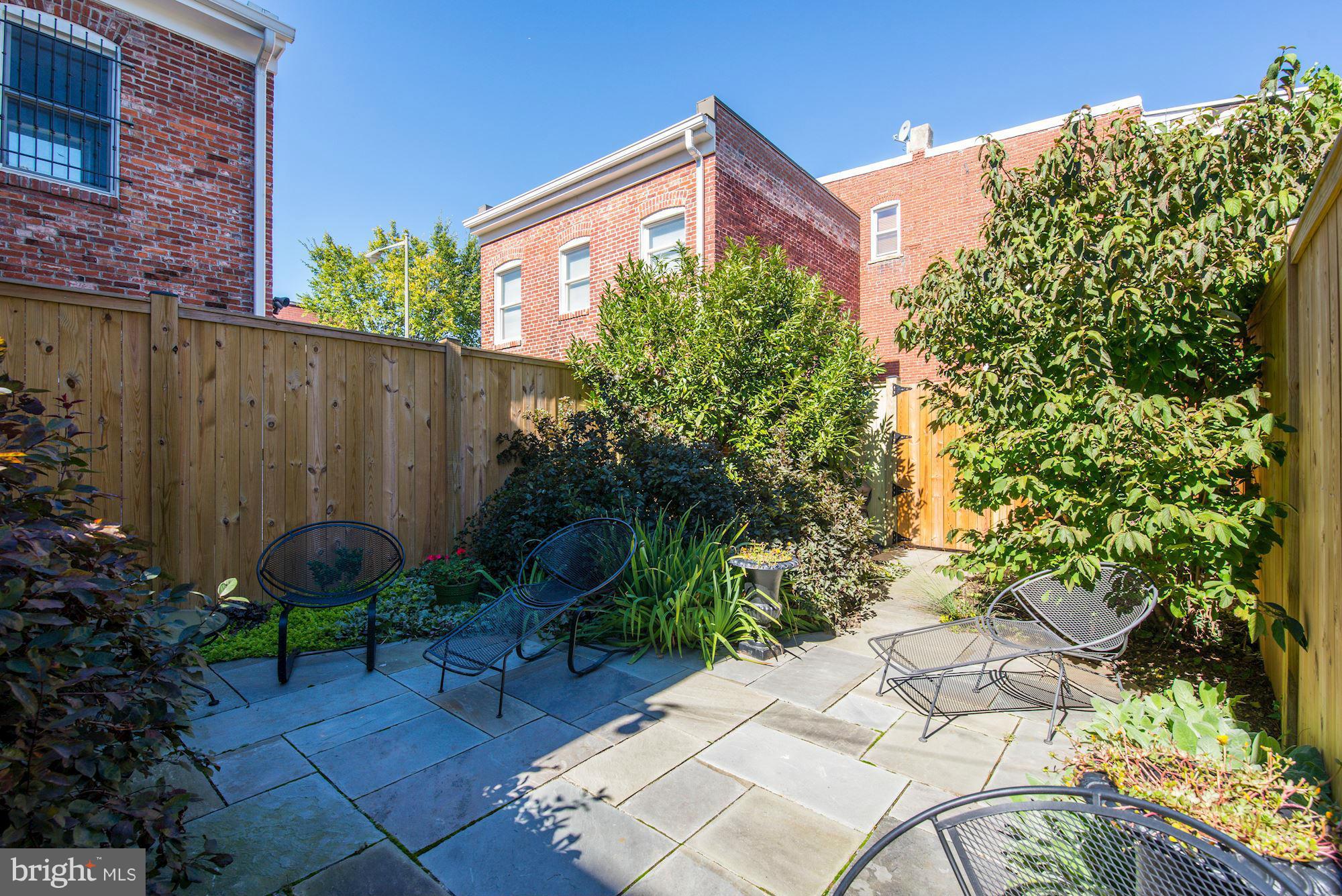 402 K Street Northeast Washington, DC 20002 - Photo 17 of 23 Lush landscaping, stone patio, and parking