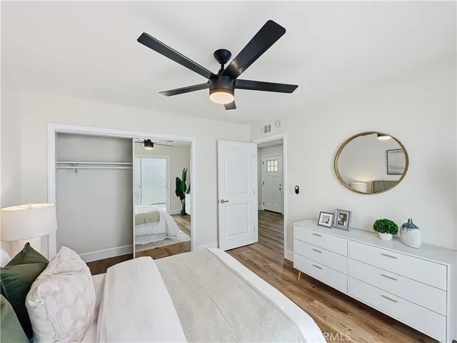 a bedroom with a large bed and a chandelier