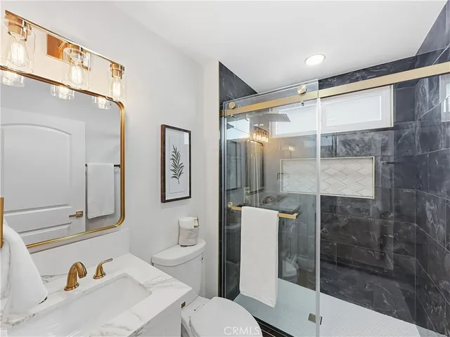 a bathroom with a sink toilet and shower