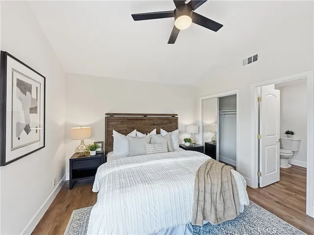 a bedroom with a bed and painting on the wall