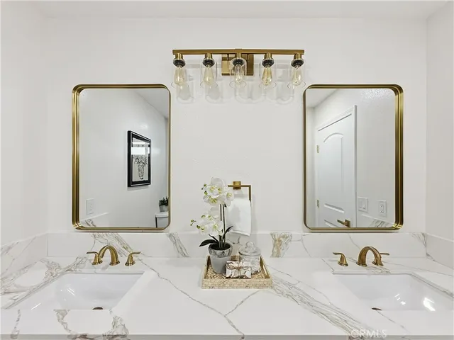 a bathroom with a sink vanity and a mirror