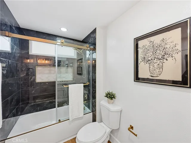 a bathroom with a shower and toilet