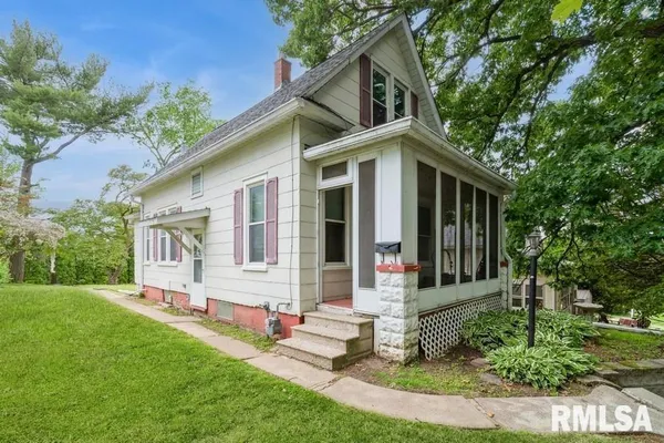 a front view of a house with a yard table and chairs