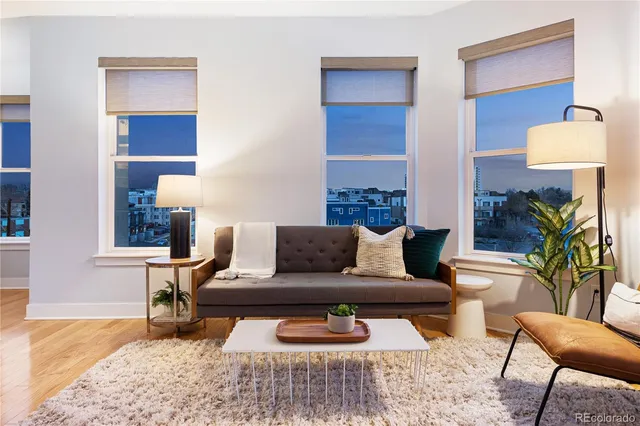 a living room with furniture and a lamp