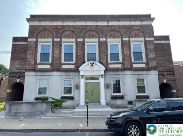 a front view of a building with parking space
