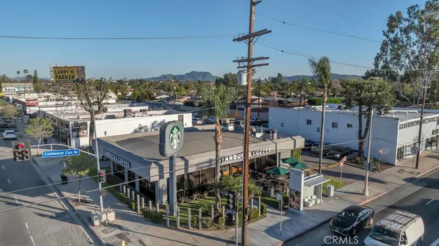 a view of a patio with table and chairs and potted plants