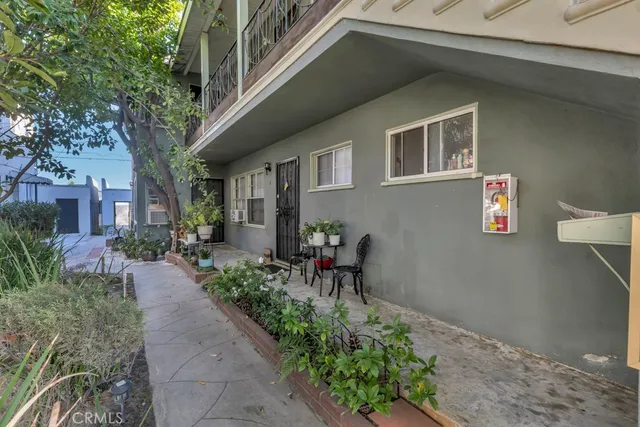 a view of a patio with table and chairs and potted plants