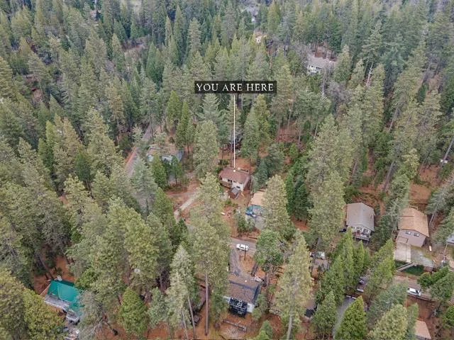 an aerial view of a house with outdoor space and street view
