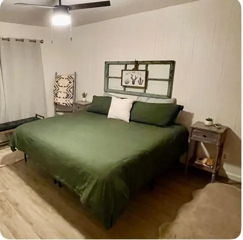 a bed sitting in a bedroom next to a window