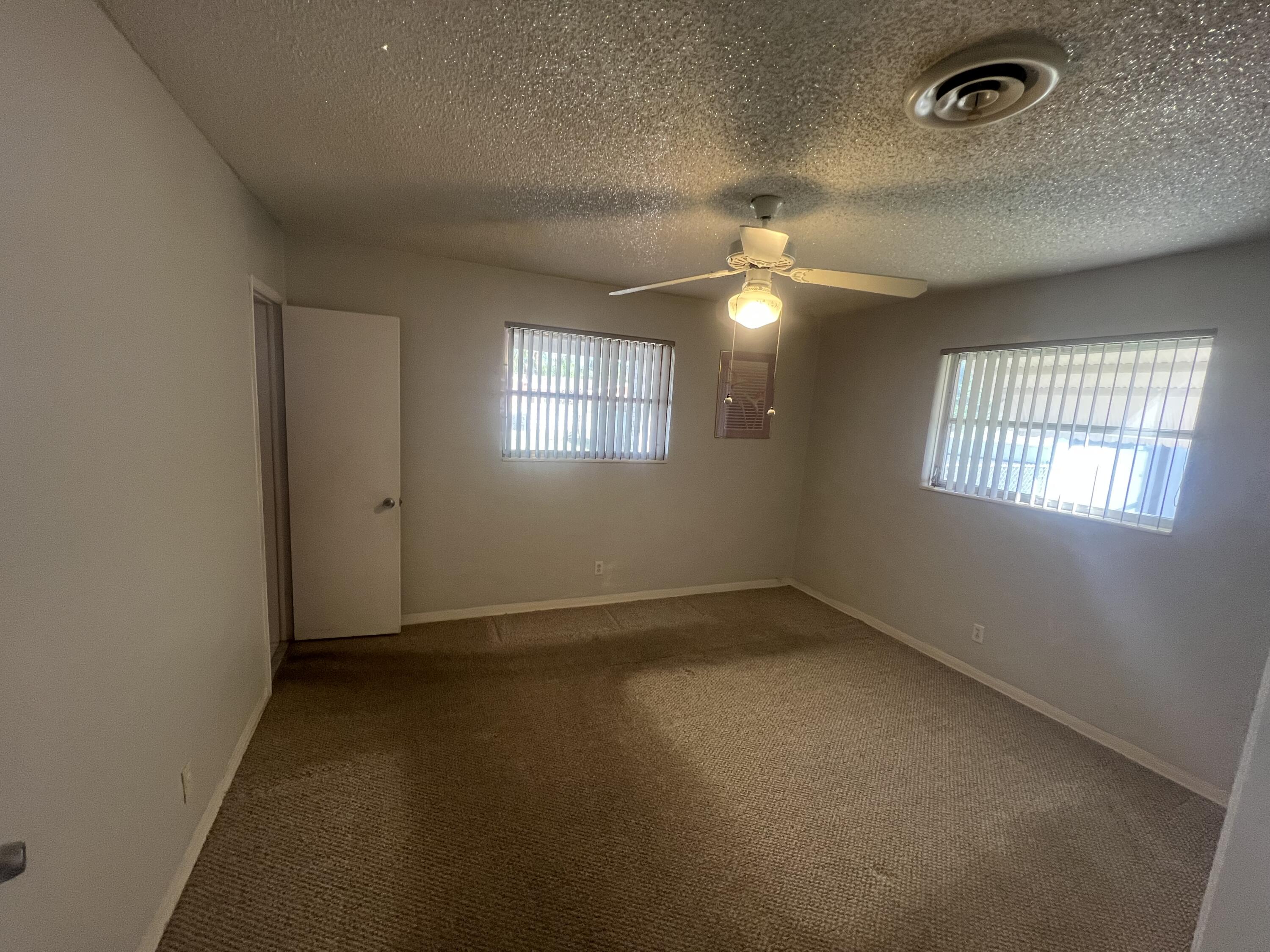 4007 Johnson Street Hollywood, FL 33021 - Photo 9 of 14 en empty room with windows and ceiling fan