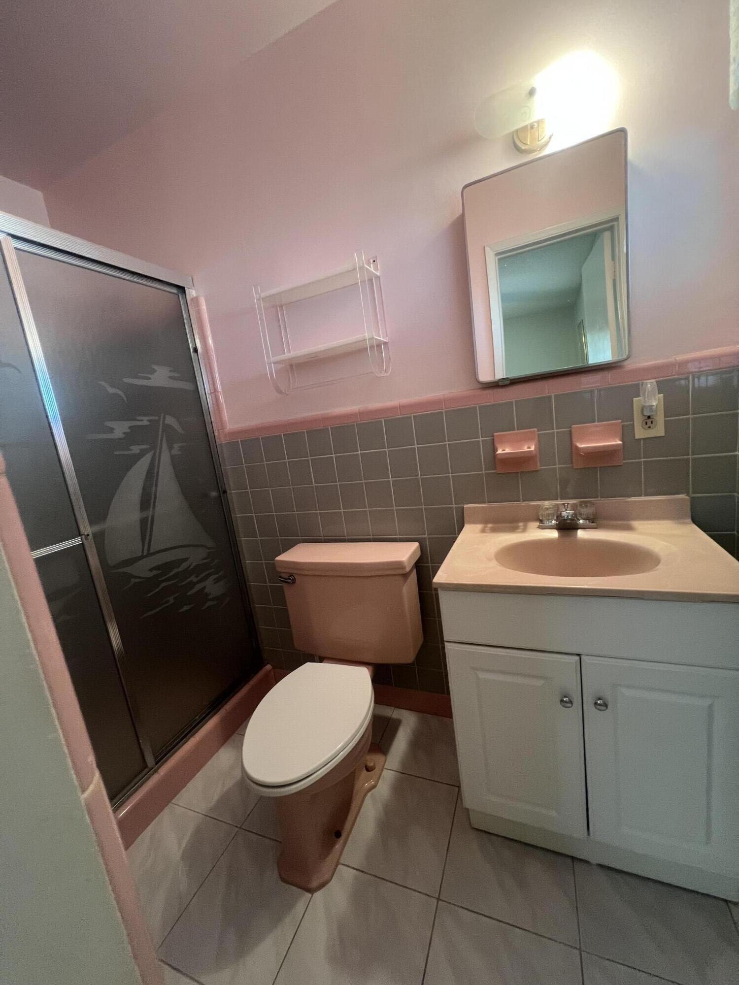 4007 Johnson Street Hollywood, FL 33021 - Photo 10 of 14 a bathroom with a toilet a sink and a mirror