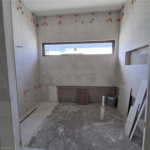 an empty room with wooden floor and glass door