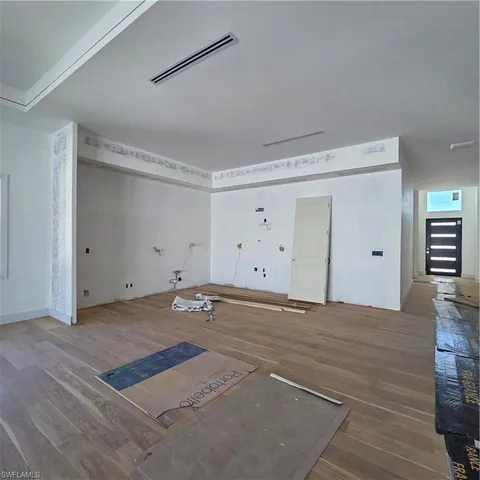 a view of a room with window and wooden floor