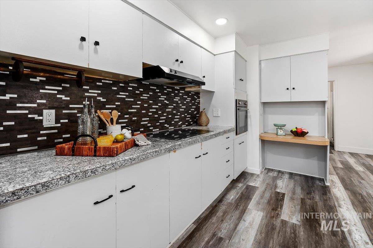 1214 H Street Rupert, ID 83350 - Photo 12 of 35 Kitchen with white cabinets, dark wood finished floors, black appliances, light countertops, and recessed lighting