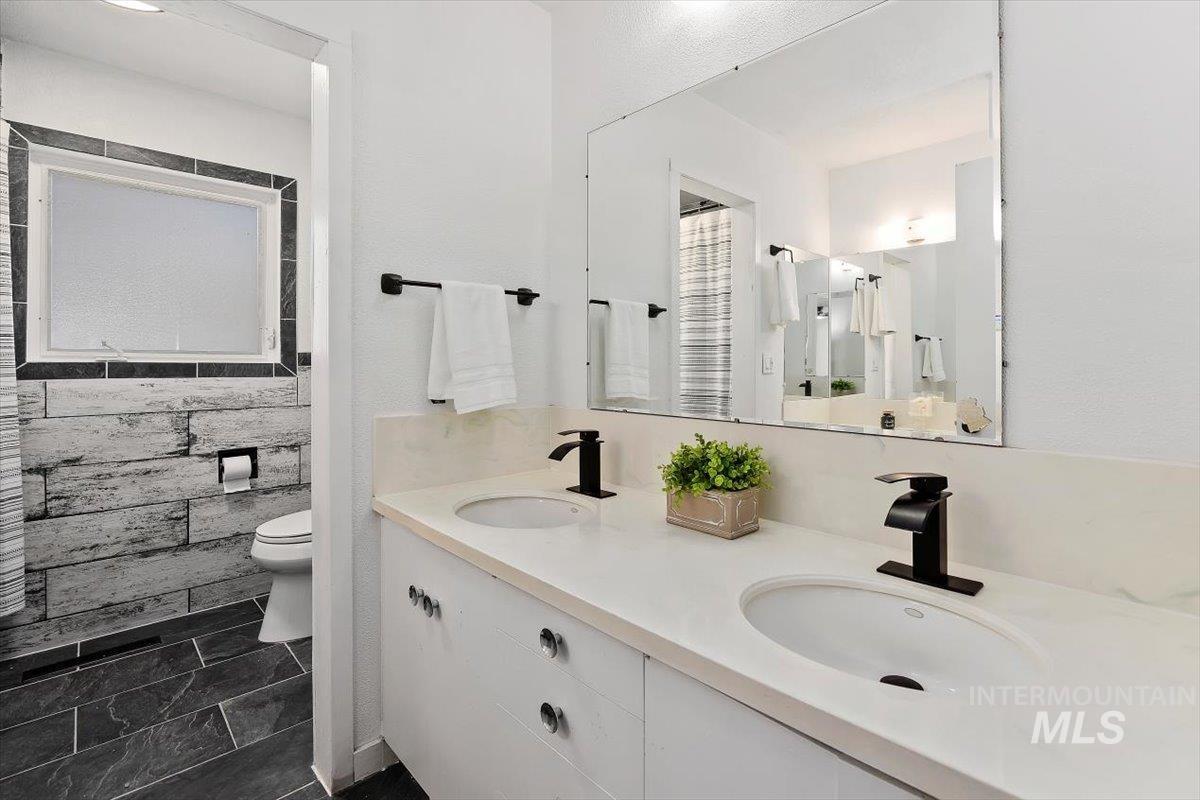 1214 H Street Rupert, ID 83350 - Photo 23 of 35 Bathroom with double vanity and tile walls