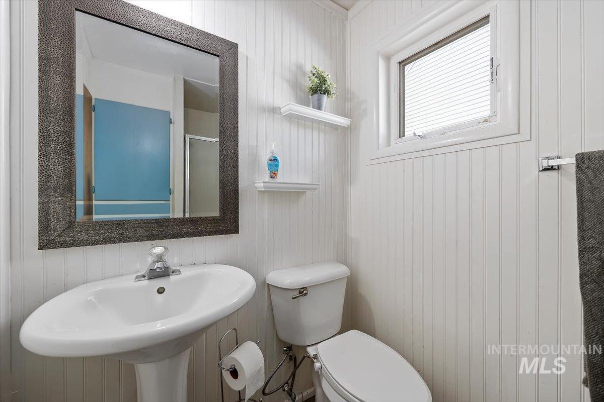 1214 H Street Rupert, ID 83350 - Photo 26 of 35 Bathroom featuring toilet and wooden walls