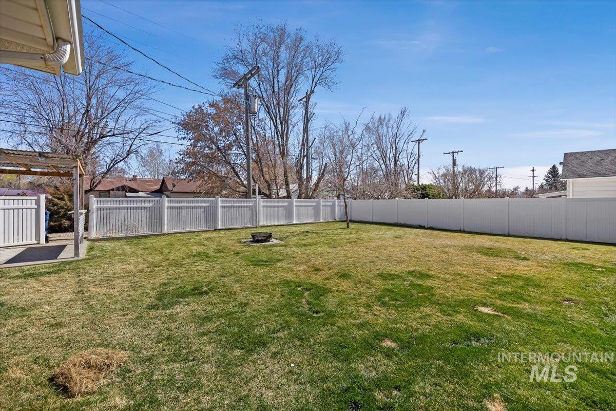 1214 H Street Rupert, ID 83350 - Photo 34 of 35 Fenced backyard with an outdoor fire pit
