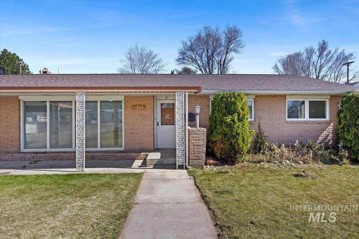 1214 H Street Rupert, ID 83350 - Photo 4 of 35 View of front of house with a front lawn, brick siding, and a shingled roof