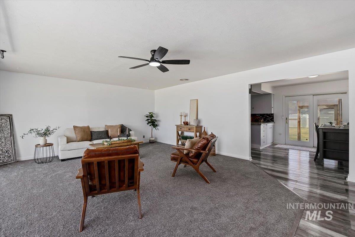 1214 H Street Rupert, ID 83350 - Photo 5 of 35 Living room with a ceiling fan and dark wood-style floors