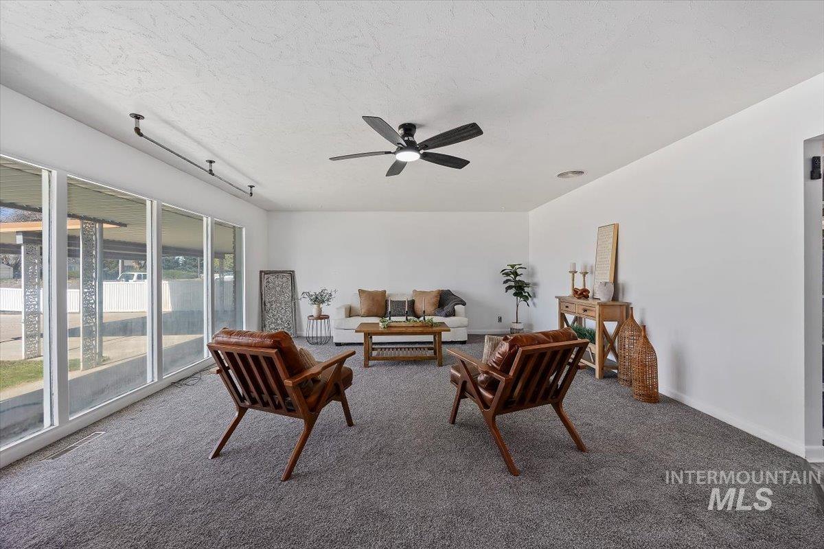 1214 H Street Rupert, ID 83350 - Photo 6 of 35 Carpeted living room with a ceiling fan and baseboards