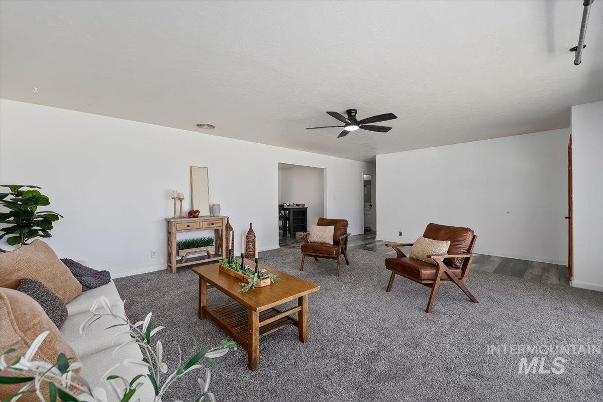 1214 H Street Rupert, ID 83350 - Photo 7 of 35 Carpeted living area with a ceiling fan and baseboards
