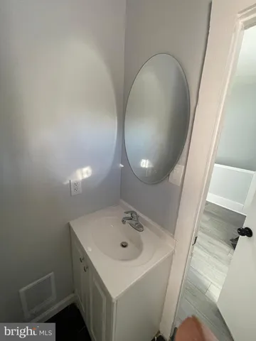 a bathroom with a sink and mirror