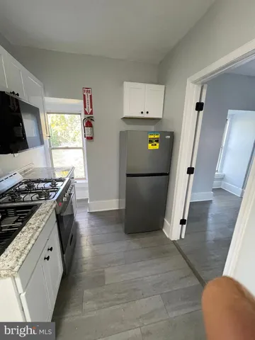 a kitchen with wooden cabinets and a stove top oven