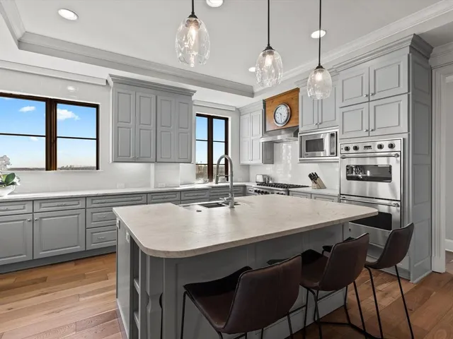 a kitchen with cabinets a center island and appliances